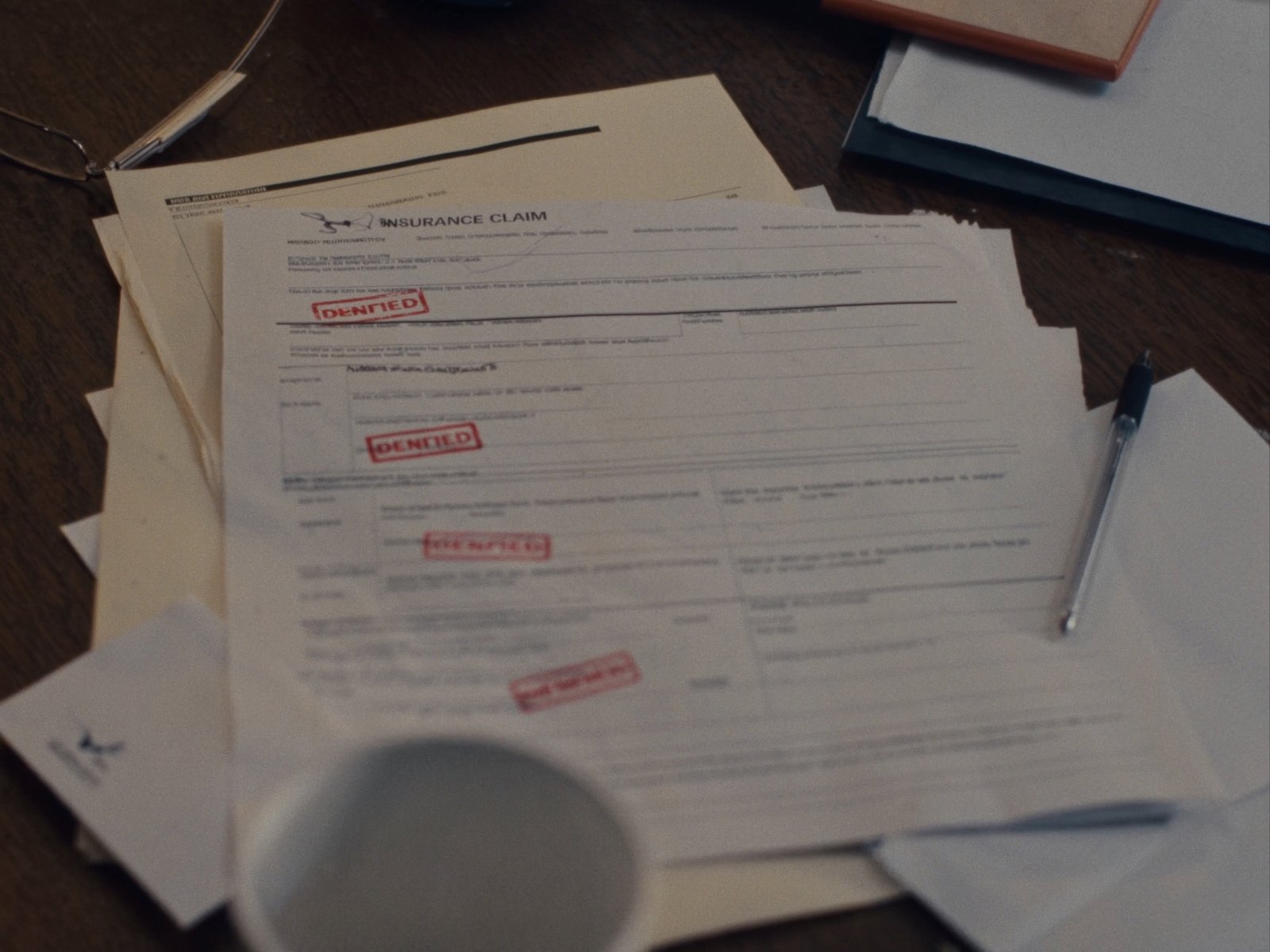 Stack of denied insurance claim forms